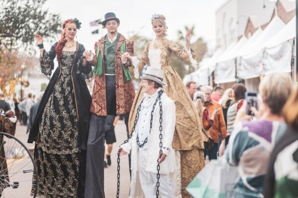 Costumed stilt walkers greet visitors during the Dickens on Centre festival on Amelia Island Costumed stilt walkers greet visitors during the Dickens on Centre festival on Amelia Island