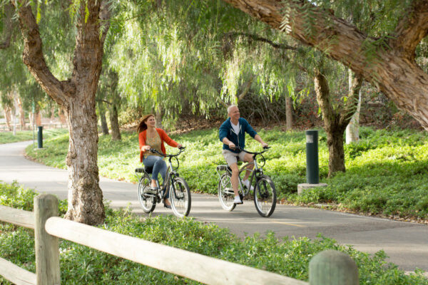 A man and a woman riding bicycles