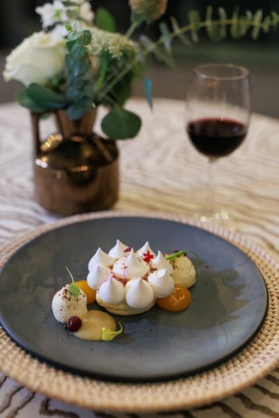 A sweet ending of Eton Mess with pink peppercorn meringue, honey curd, cranberry compote, and Florida citrus chantilly by chef McKibbin
