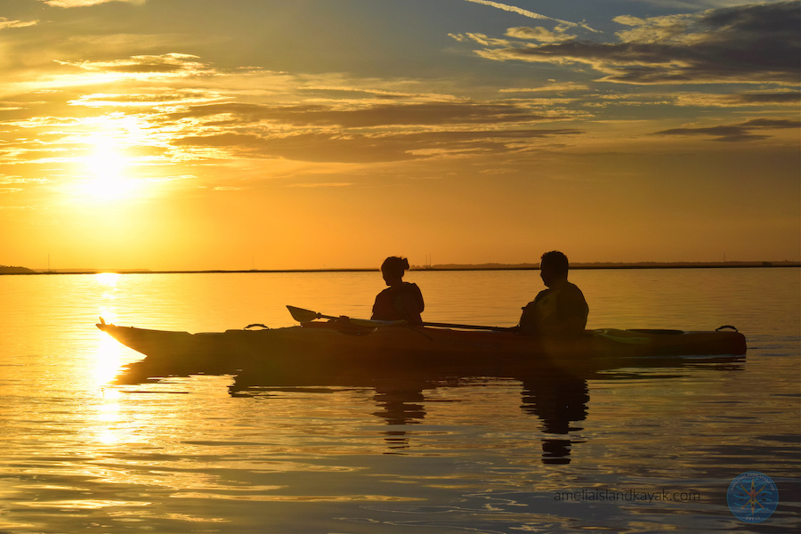kayaking couple at sunset