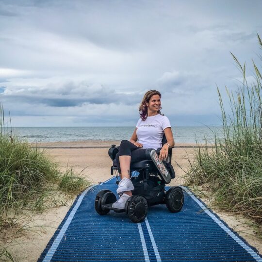 woman in wheelchair on beach