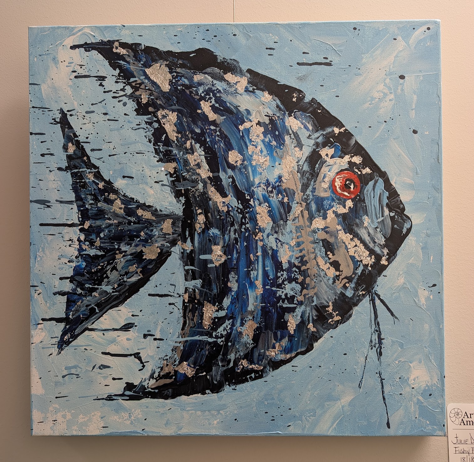A painting of a blue and black angelfish with bold brushstrokes, splashes of white and beige, and a bright red eye against a light blue background. The fish is shown in profile, facing right.