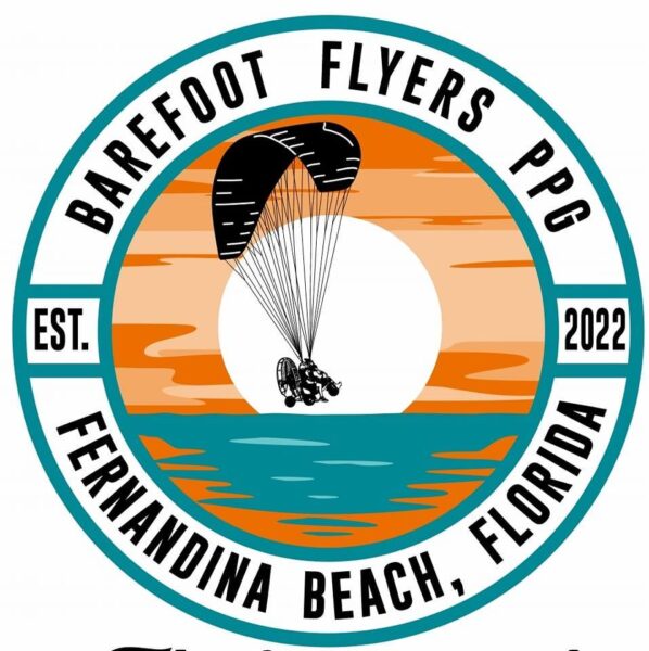 Circular logo for Barefoot Flyers PPG, Fernandina Beach, Florida, established 2022, featuring a sunset over water with a person flying a powered paraglider in the center.