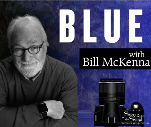 A smiling older man with glasses and a beard sits with his arms crossed. Text reads BLUE with Bill McKenna. A large camera and Story & Song Center for Arts & Culture logo appear in the bottom right corner.