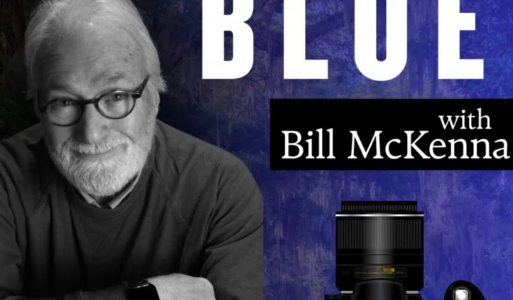 A smiling older man with glasses and a beard sits with his arms crossed. Text reads BLUE with Bill McKenna. A large camera and Story & Song Center for Arts & Culture logo appear in the bottom right corner.