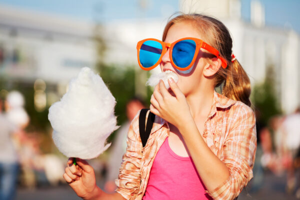 girl eating cotton candy