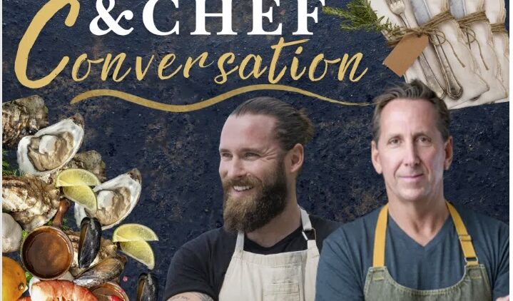 Two male chefs wearing aprons stand in front of a dark blue background decorated with seafood and bundled napkins. Text reads “Cookbook & Chef Conversation,” with the Story & Song Center for Arts & Culture logo in the corner.