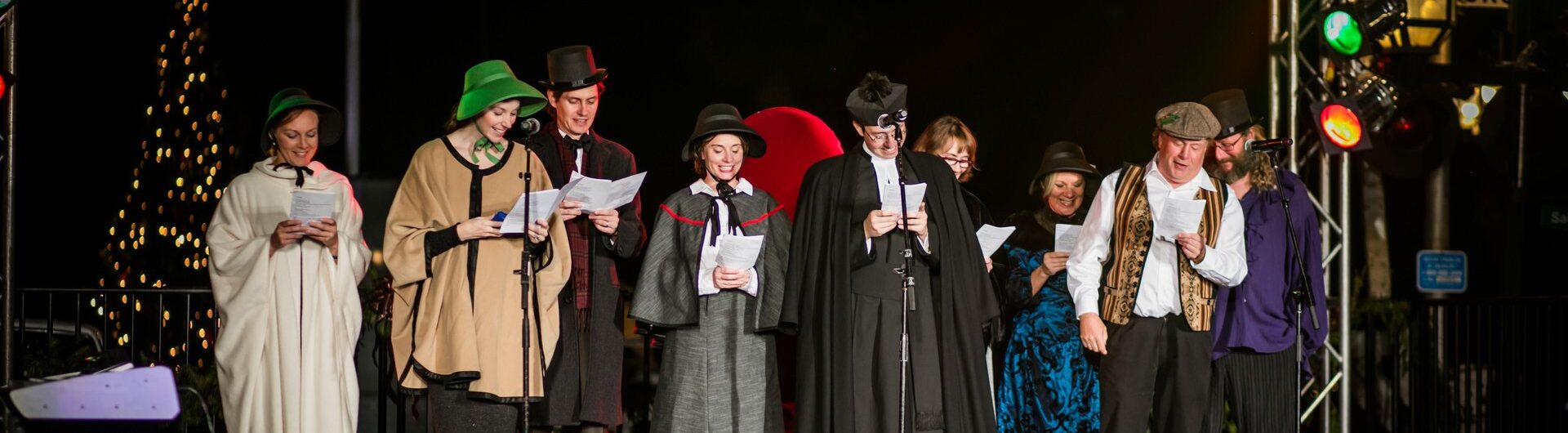 Victorian-costumed performers sing on stage during the Dickens on Centre festival on Amelia Island