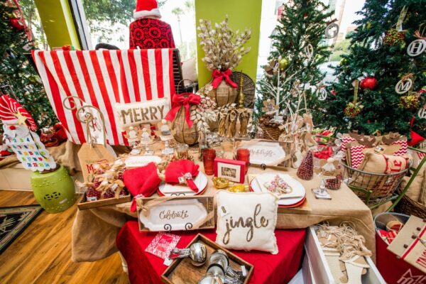 Festive holiday display with Christmas decorations, red and white accents, and gifts during Dickens on Centre on Amelia Island