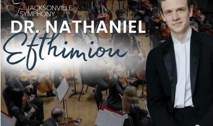 A smiling man in a tuxedo sits in front of an orchestra. Text reads Jacksonville Symphony, Dr. Nathaniel Efthimiou. The Story & Song Center for Arts & Culture logo appears in the lower left corner.