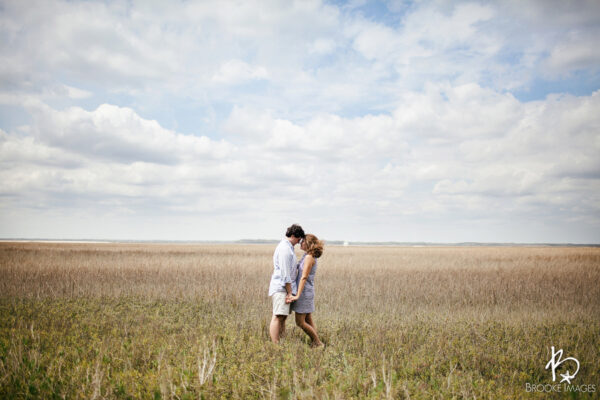 couple posing together in field