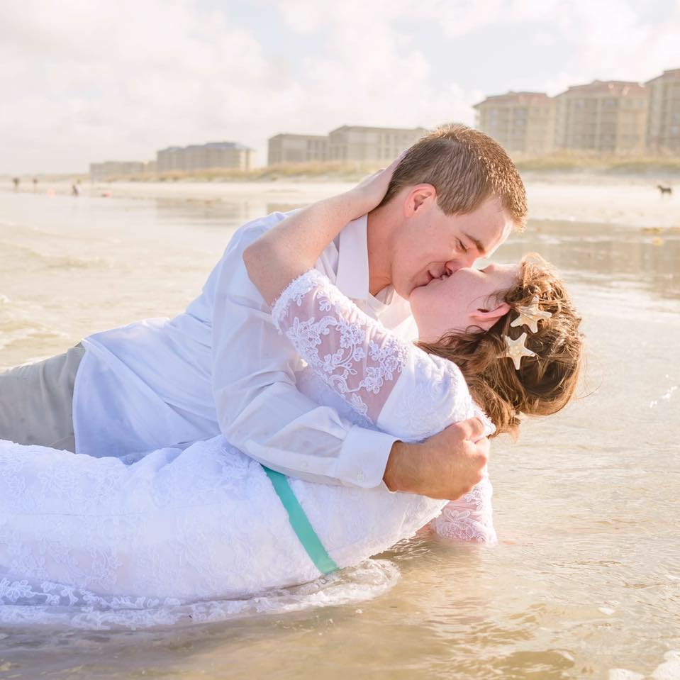couple kissing in waves