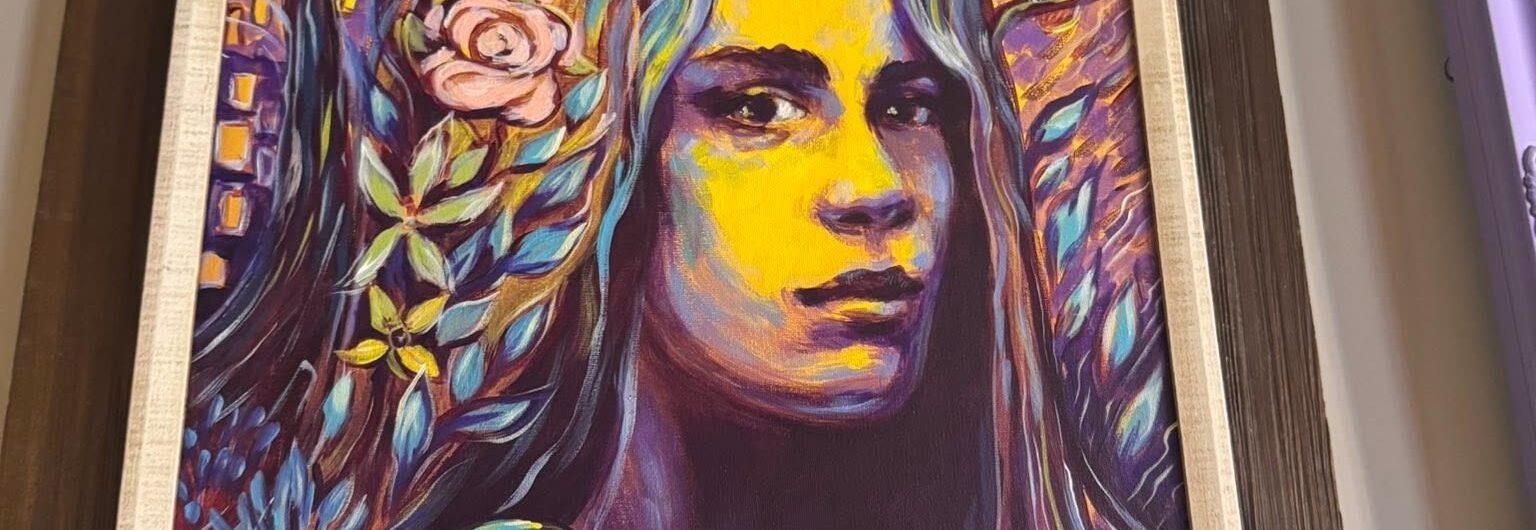 A vibrant painting of a woman’s face with long hair, surrounded by flowers, mushrooms, and trees in bold purples, blues, and yellows. A crescent moon and small houses are in the colorful, mystical background.