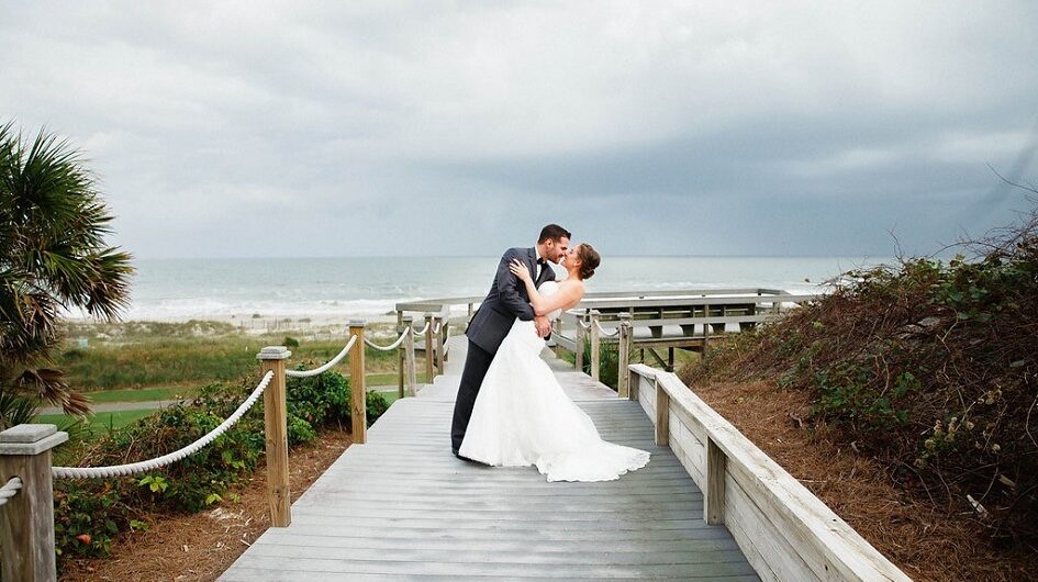 Amelia Island Weddings couple kissing on boardwalk