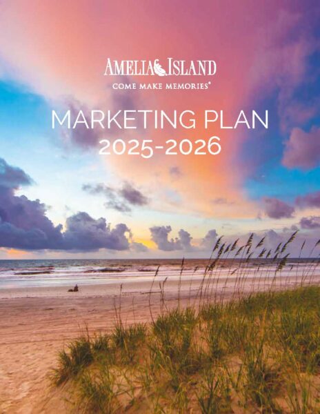 A vibrant sunset sky over the beach at Amelia Island with sea grass in the foreground. Text reads: Amelia Island Come Make Memories Marketing Plan 2025-2026.