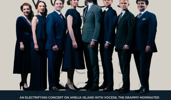 Eight formally dressed vocalists from the ensemble VOCES8 stand in a line facing the camera. Event details below announce their concert on March 4, 2026, at 7:00 PM at Amelia Plantation Chapel.