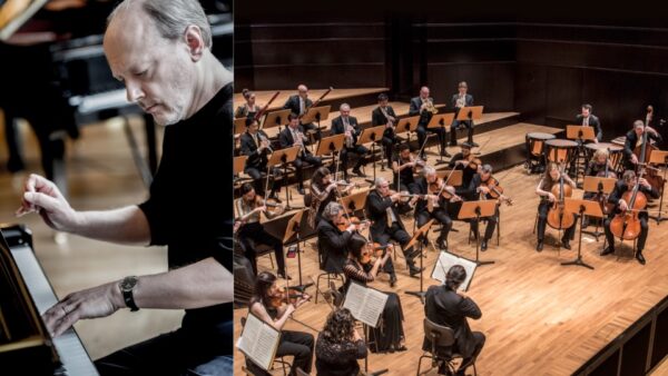 A man plays a grand piano on the left, while an orchestra with string and wind instruments performs on stage on the right. The musicians are seated in a concert hall with wooden floors.