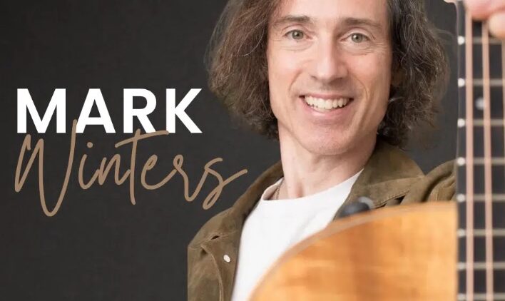 A smiling man with shoulder-length brown hair holds an acoustic guitar. The text “Mark Winters” is written beside him. The Story & Song Center for Arts & Culture logo appears in the lower left corner.