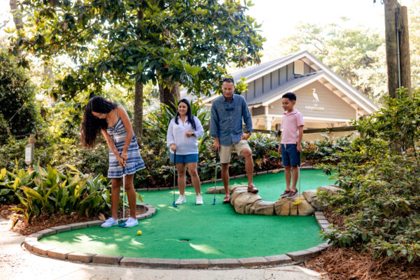 The Villas of Amelia Island family playing golf