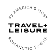 Travel + Leisure logo with text: #3 Americas Most Romantic Towns forming a circle around the logo on a light background.