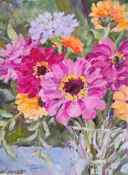 A vibrant painting of pink, purple, orange, and yellow flowers with green leaves. The brushstrokes create a textured, lively bouquet against a soft green background.