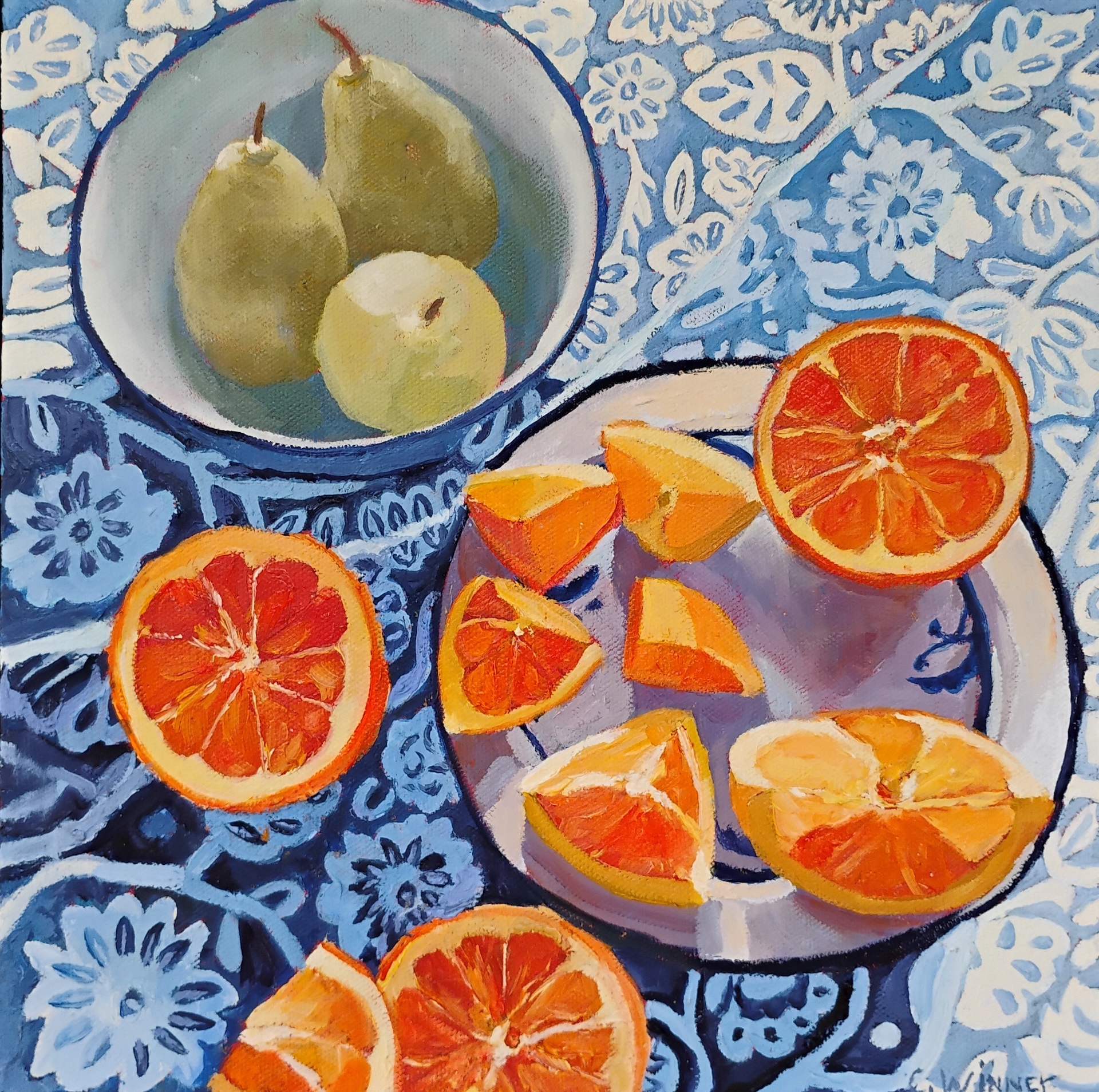 A vibrant painting depicts pears in a bowl and sliced oranges on plates, resting on a blue patterned tablecloth with floral and leaf designs. The fruits vivid colors contrast with the cool blue background.