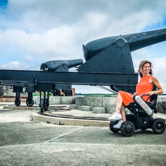 woman in wheelchair next to cannon