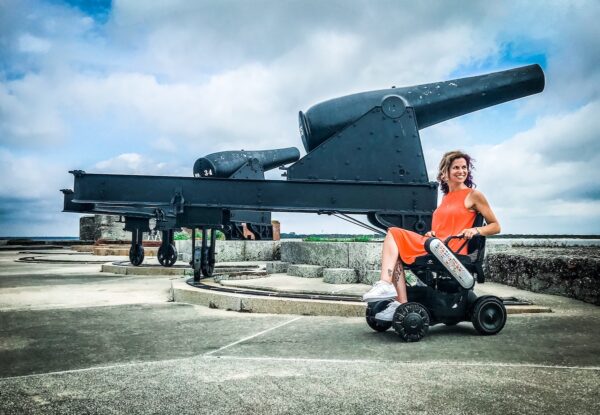 woman in wheelchair next to cannon
