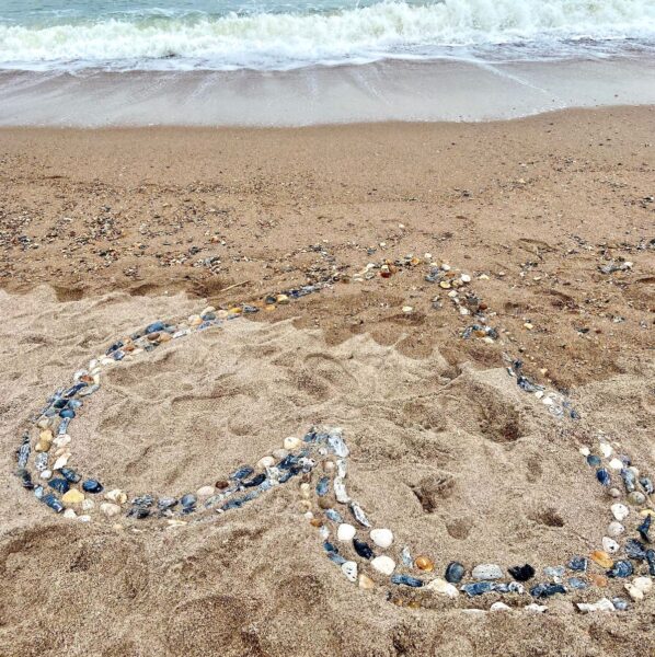 heart made of rocks on beach