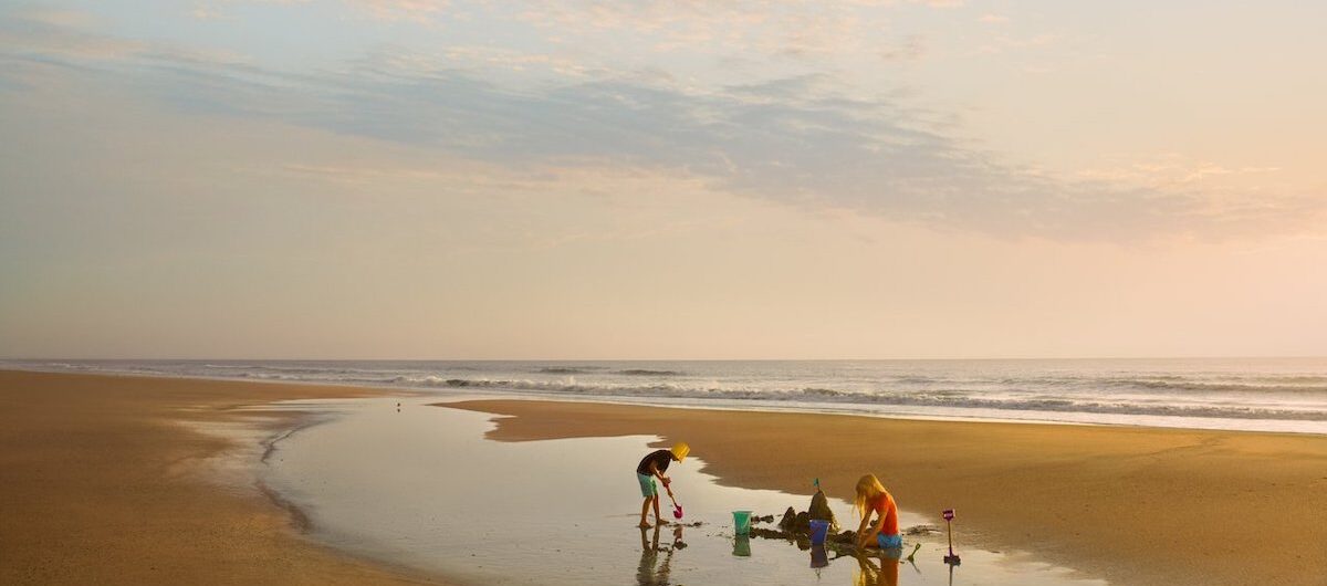 family building sandcastle on beach