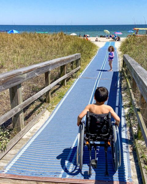boy in wheelchair on beach