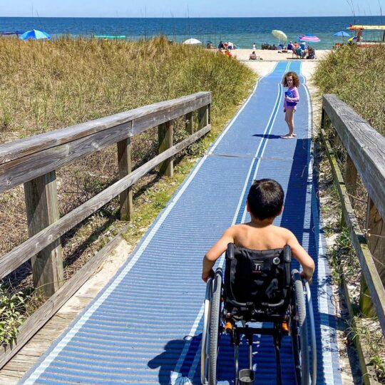 boy in wheelchair on beach