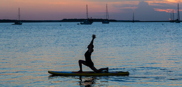 woman stretching on paddleboard