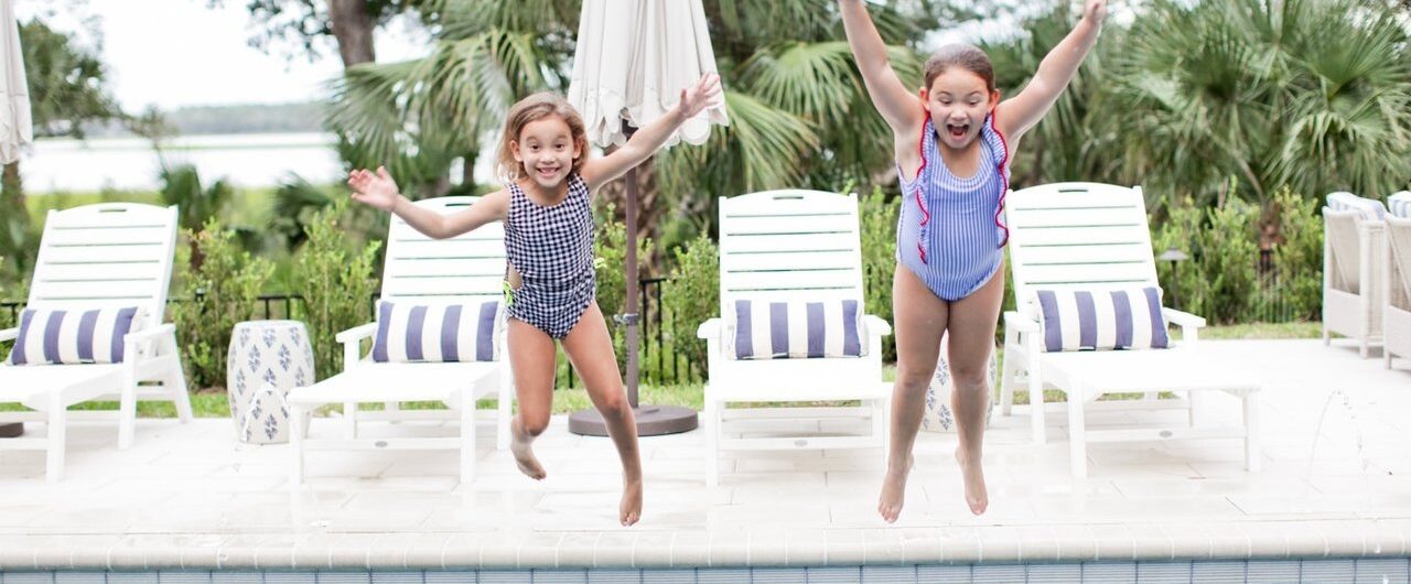 girls jumping into pool